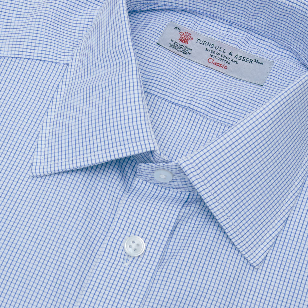 The Turnbull & Asser Blue Grid Check Shirt features a T&A collar, 3-button cuffs, and a refined blue and white grid pattern, displayed against a white background.