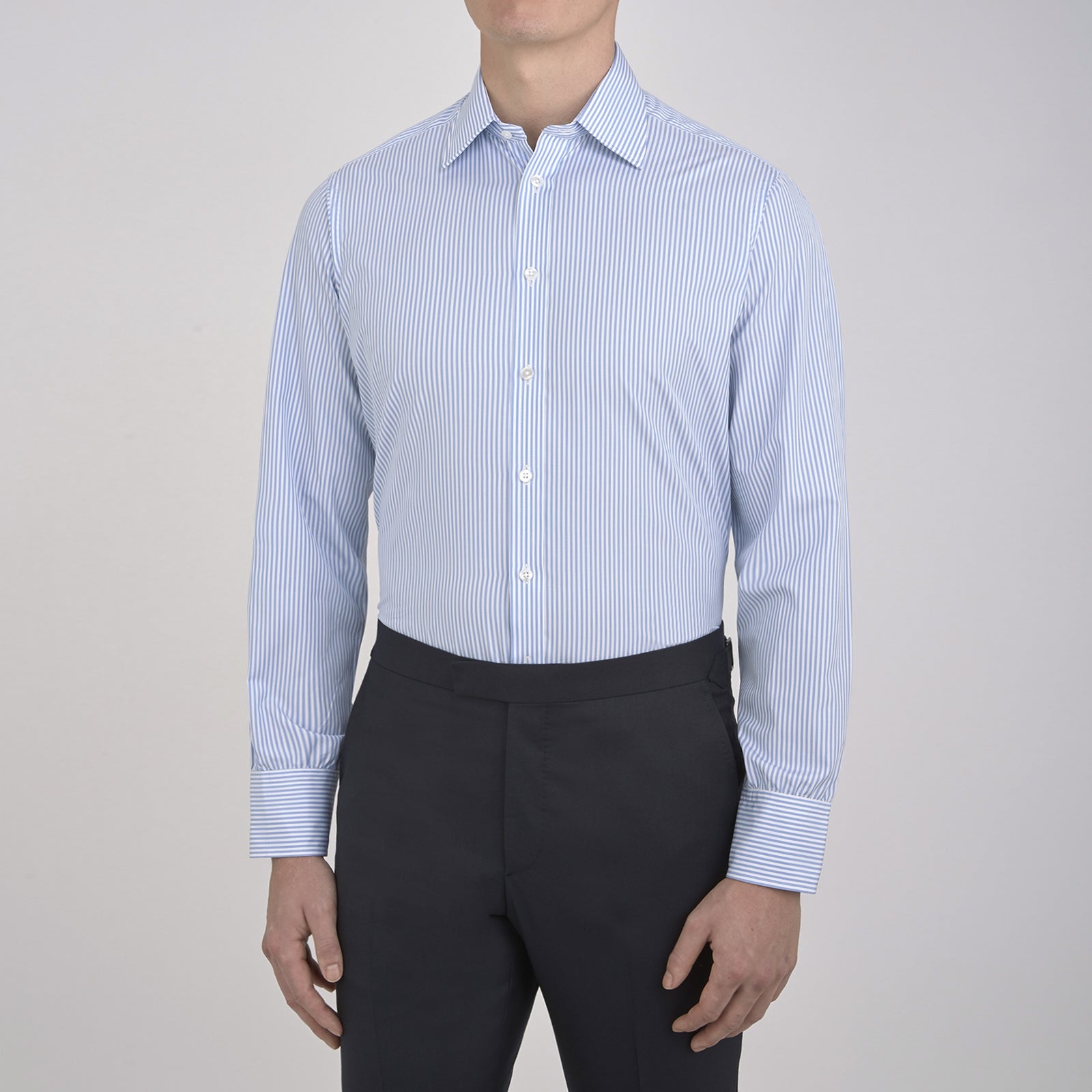 View 6 of product The Turnbull & Asser Light Blue Bengal Stripe Shirt features white vertical stripes, a classic T&A collar, and 3-button cuffs. Buttoned down the front, it’s laid flat on a white background for a timeless British look.