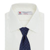 View 4 of product The Turnbull & Asser Cream Herringbone Superfine Cotton Shirt features a T&A collar, double cuffs, and a subtle pattern. It is neatly folded with white buttons and displayed on a plain white background.