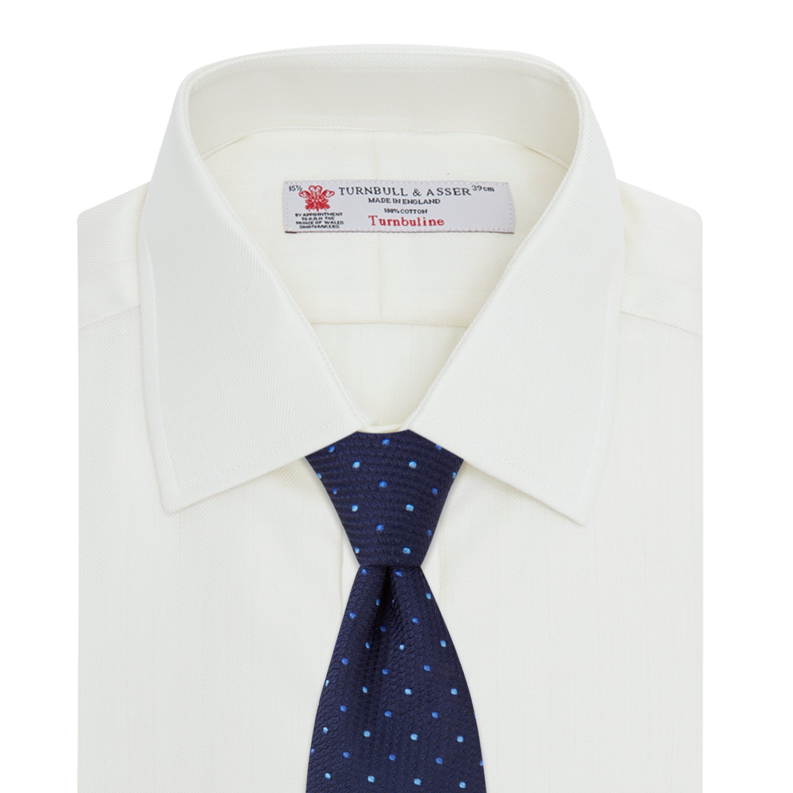 View 4 of product The Turnbull & Asser Cream Herringbone Superfine Cotton Shirt features a T&A collar, double cuffs, and a subtle pattern. It is neatly folded with white buttons and displayed on a plain white background.