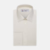 View 1 of product The Turnbull & Asser Cream Herringbone Superfine Cotton Shirt features a T&A collar, double cuffs, and a subtle pattern. It is neatly folded with white buttons and displayed on a plain white background.