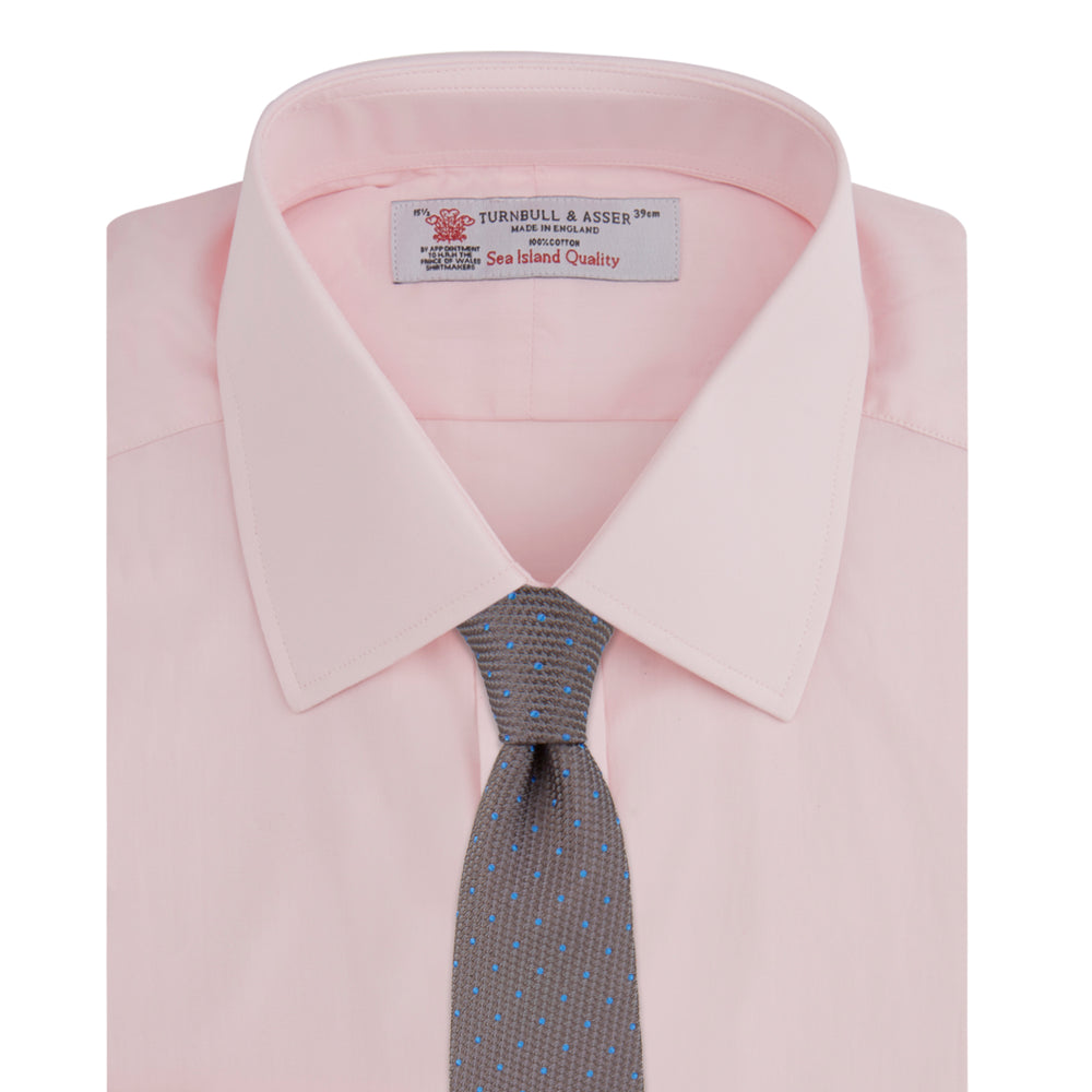 A Turnbull & Asser Light Blue and Navy Piped Silk Pocket Square is shown against a plain white background, highlighting its classic design and fine detailing.