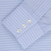 View 2 of product The Turnbull & Asser Light Blue Rich Stripe Shirt features a T&A collar, three-button cuffs, and fine white vertical stripes. Shown neatly laid flat on a white background.