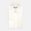 View 1 of product The Turnbull & Asser Tailored Fit Cream Pleated Front Silk Dress Shirt with T&A collar and double cuffs is displayed neatly folded against a light gray background.