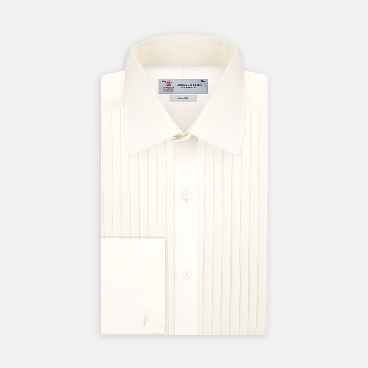 View 1 of product The Turnbull & Asser Tailored Fit Cream Pleated Front Silk Dress Shirt with T&A collar and double cuffs is displayed neatly folded against a light gray background.