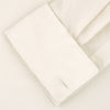 View 6 of product The Turnbull & Asser Tailored Fit Cream Pleated Front Silk Dress Shirt with T&A collar and double cuffs is displayed neatly folded against a light gray background.