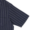 View 3 of product The Turnbull & Asser Holiday Fit Stripe Linen Short Sleeve Shirt features a navy background with vertical white stripes, a revere collar, and white buttons.