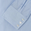 View 3 of product The Turnbull & Asser Tailored Fit Light Blue and White Pinstripe Shirt features a Bury collar and 3-button cuffs, neatly folded and displayed on a plain white background.