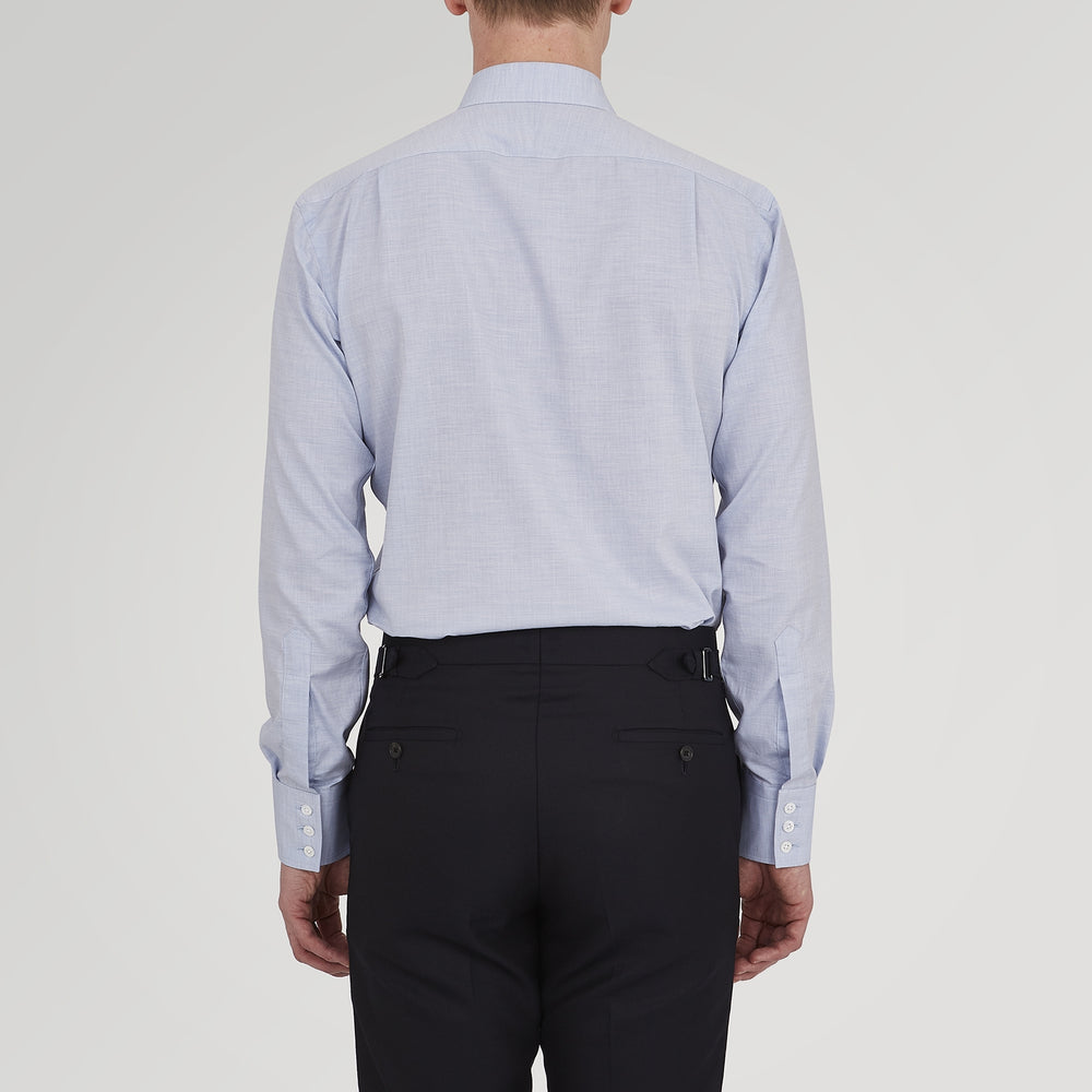 A neatly folded Tailored Fit Light Blue Flannel Shirt by Turnbull & Asser with a Bury collar and 3-button cuffs, displayed on a plain white background, features an inner collar label.