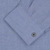 View 4 of product The Turnbull & Asser Weekend Fit Blue Cashmerello Light Shirt features a Dorset collar, 1-button cuffs, subtle check pattern, front pocket, and white buttons—softly folded on a white background.