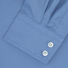 View 2 of product The Turnbull & Asser Tailored Fit Deep Blue Cotton Shirt features a classic Kent collar and 2-button cuffs, shown neatly folded with white buttons against a plain white background.