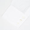 View 2 of product A neatly folded white Turnbull & Asser shirt, tailored fit with a Kent collar and 3BC PLA details, pearl-like buttons, and signature cuffs, is displayed against a light grey background. The label reads Turnbull & Asser.