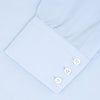 View 2 of product A neatly folded Turnbull & Asser Tailored Fit Two-Fold 120 Light Blue Shirt with a Kent collar and 3-button cuffs is displayed against a plain light gray background.