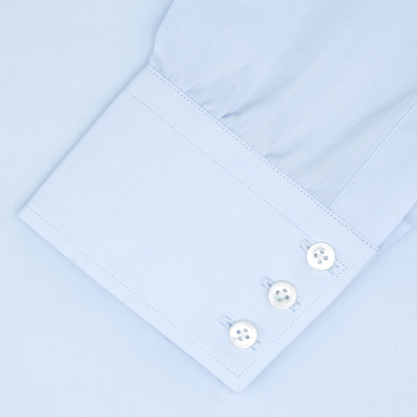View 2 of product A neatly folded Turnbull & Asser Tailored Fit Two-Fold 120 Light Blue Shirt with a Kent collar and 3-button cuffs is displayed against a plain light gray background.