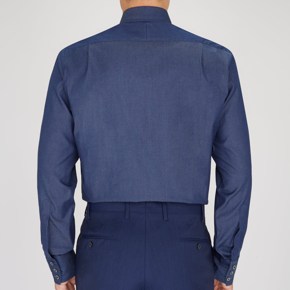 A neatly folded Turnbull & Asser Dark Blue Denim-Cashmere Dress Shirt with T&A collar and 3-button cuffs, showcased on a plain light background, offers a refined formal alternative.