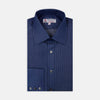 View 1 of product A neatly folded Turnbull & Asser Dark Blue Denim-Cashmere Dress Shirt with T&A collar and 3-button cuffs, showcased on a plain light background, offers a refined formal alternative.