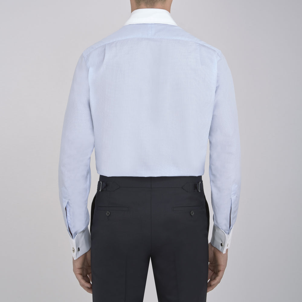 A neatly folded The Great Gatsby Cotton Shirt by Turnbull & Asser, featuring a light blue body, white rounded collar, and double cuffs inspired by 1920s style, displayed on a plain light background.