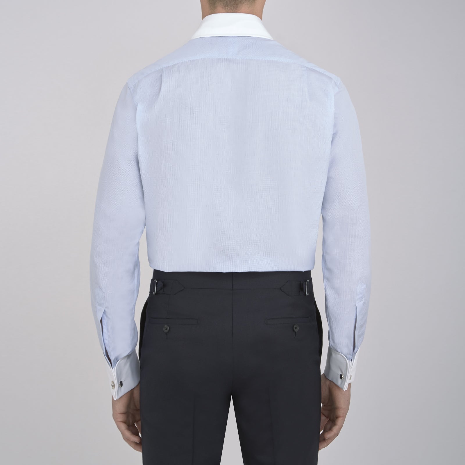 View 3 of product A neatly folded The Great Gatsby Cotton Shirt by Turnbull & Asser, featuring a light blue body, white rounded collar, and double cuffs inspired by 1920s style, displayed on a plain light background.