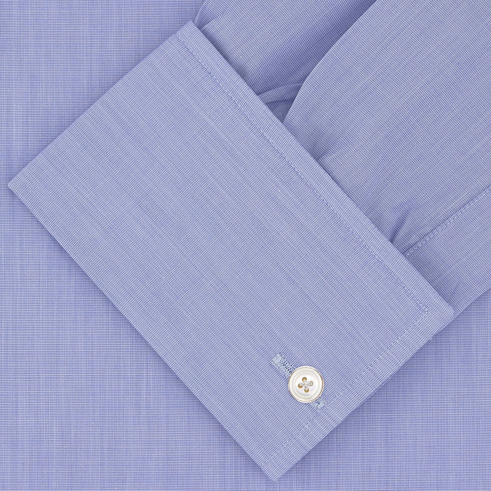 View 2 of product A neatly folded dark blue Sea Island quality cotton shirt by Turnbull & Asser, featuring a T&A collar, double cuffs, and white buttons, is displayed against a plain white background.