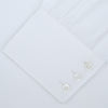 View 2 of product A Turnbull & Asser White Self-On-Self Herringbone Sea Island Quality Cotton Shirt with a Regent collar and 3-button cuffs, neatly folded and displayed on a light grey background.