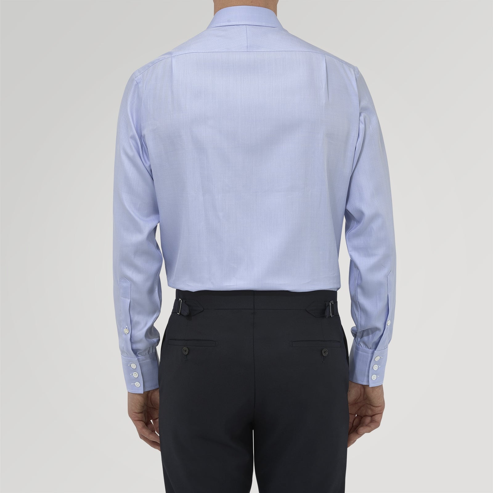 View 3 of product The Blue Herringbone Sea Island Quality Cotton Shirt by Turnbull & Asser features a T&A collar, 3-button cuffs, and is crafted from luxurious cotton. The shirt is displayed neatly folded on a plain white background.