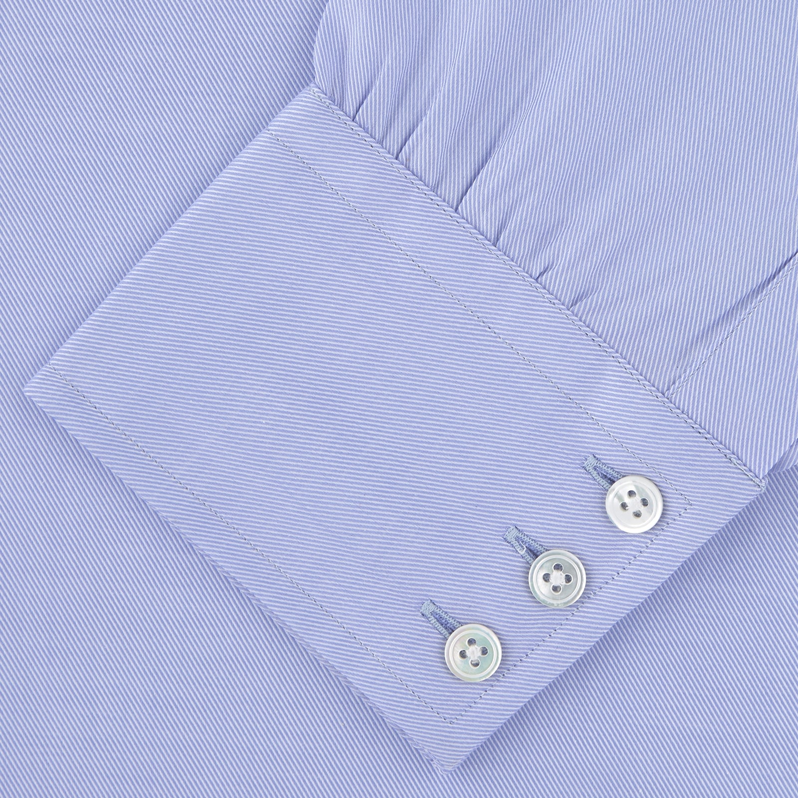 View 4 of product The Turnbull & Asser Blue Sea Island Quality Cotton Twill Shirt features a T&A collar, chest pocket, white buttons, and 3-button cuffs, all showcased on a plain white background.