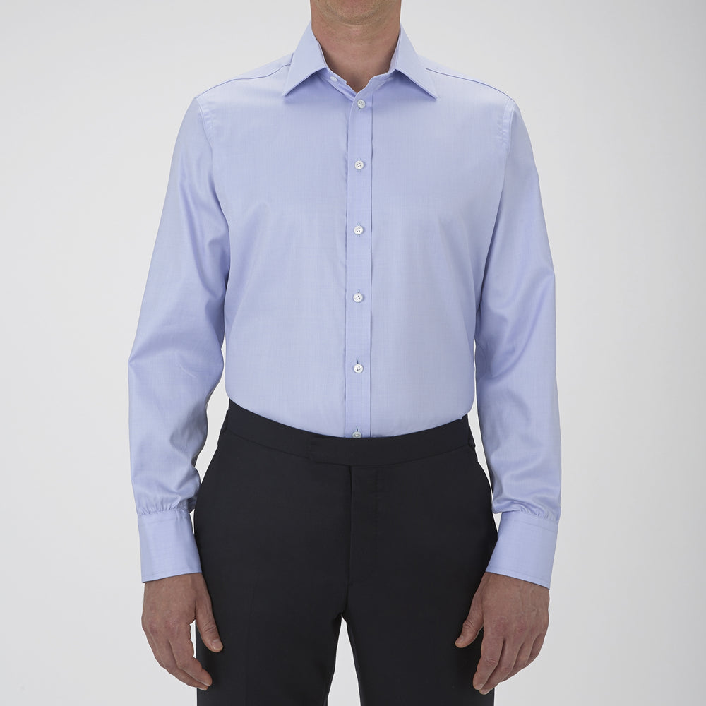 The Turnbull & Asser Blue Sea Island Quality Cotton Twill Shirt features a T&A collar, chest pocket, white buttons, and 3-button cuffs, all showcased on a plain white background.