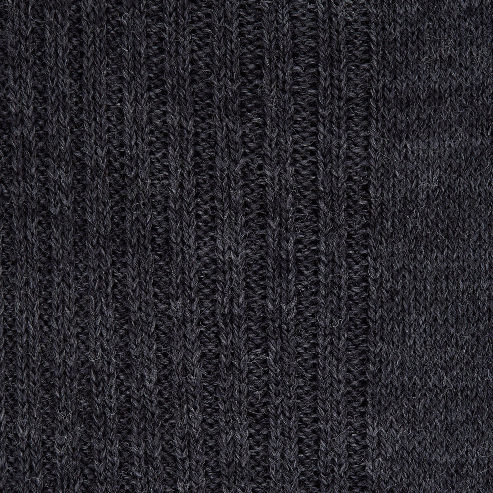 The Turnbull & Asser Dark Grey Mid-Length Merino Wool Sock, ideal as a men’s dress sock, is showcased upright against a plain light gray background.
