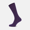 View 1 of product A single Turnbull & Asser Dark Purple Mid-Length Merino Wool Sock stands upright on a plain light gray background, showcasing its ribbed texture and reinforced toe and heel for premium quality.