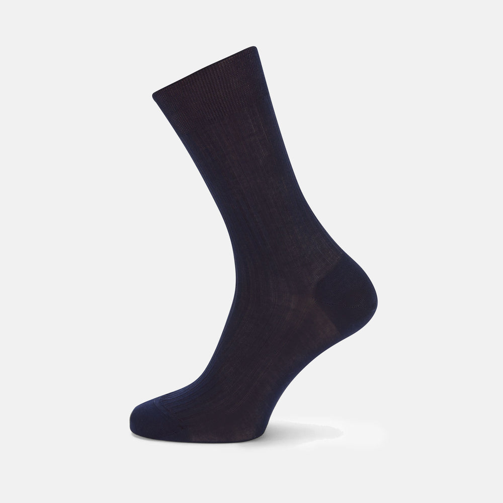 A single Turnbull & Asser Navy Short Cotton Sock stands upright against a light gray background, highlighting the refined elegance and luxury of premium men’s socks.