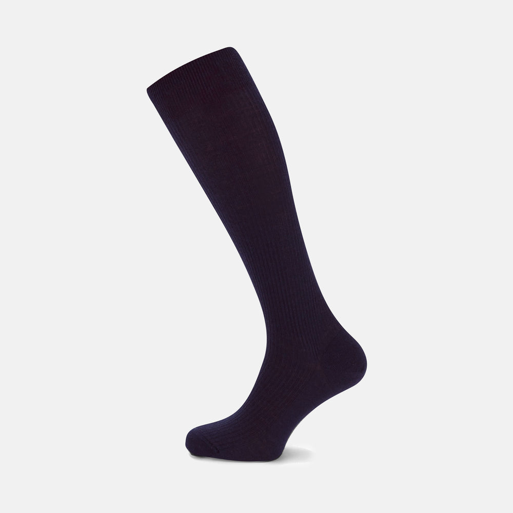 A single Deep Navy Long Merino Wool Sock by Turnbull & Asser is shown on a mannequin leg against a plain light gray background.
