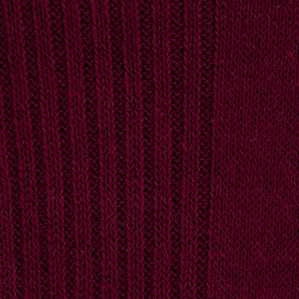 A single Bordeaux Long Merino Wool Sock by Turnbull & Asser stands upright on a light gray background, showcasing the brand’s luxurious men’s sock style.