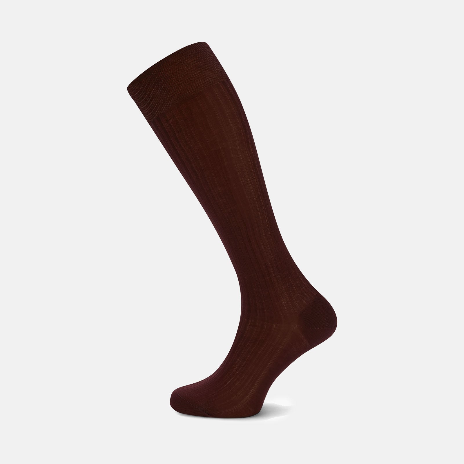 View 1 of product The Turnbull & Asser Oxblood Long Cotton Sock, crafted from premium Fil d’Ecosse with a ribbed texture, is displayed in side profile on a white background, showcasing its luxury men’s design and rich dark brown color.