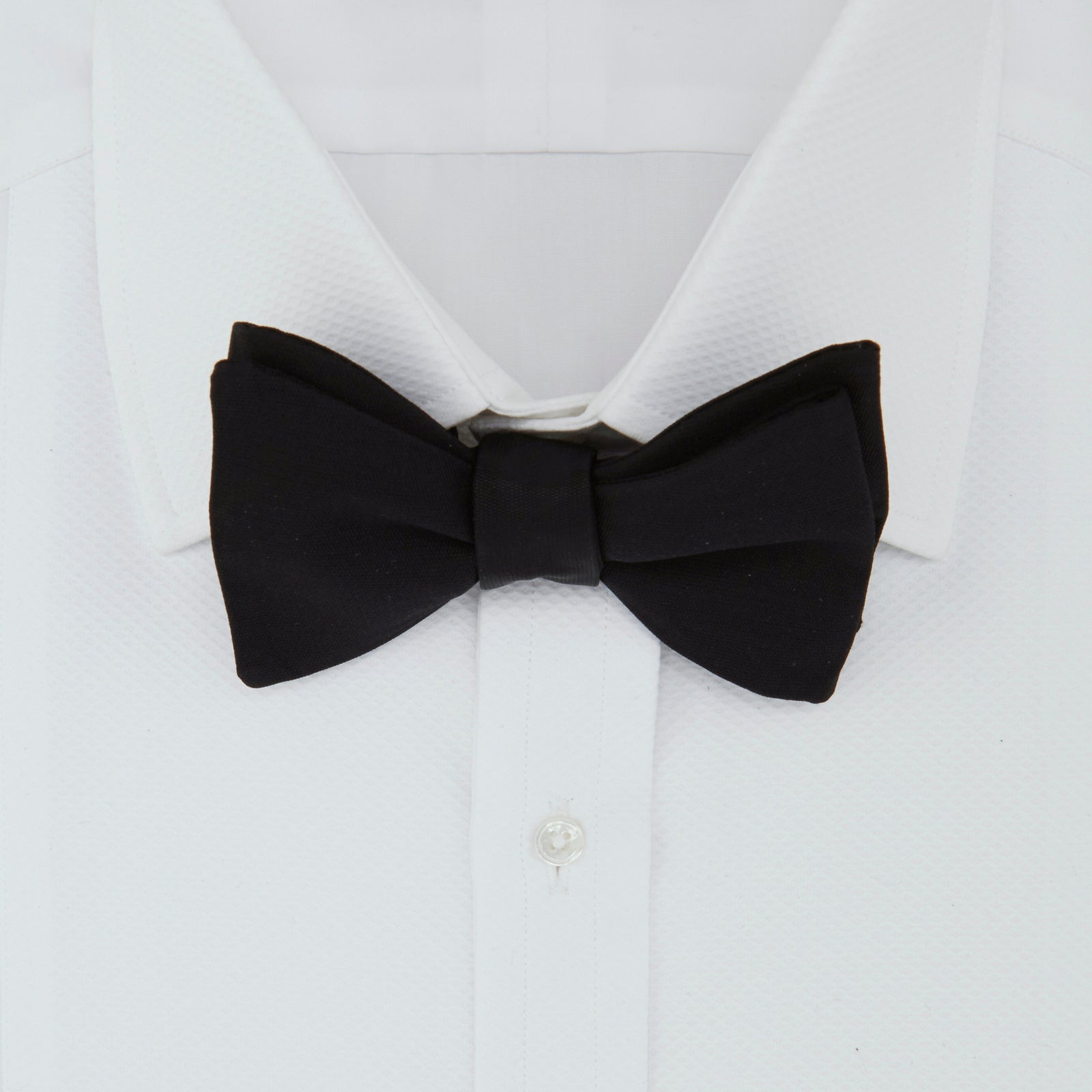 View 2 of product The Turnbull & Asser Black Barathea Bow Tie, made from luxurious silk with a classic, symmetrical shape, is displayed against a plain white background—ideal for formal occasions.