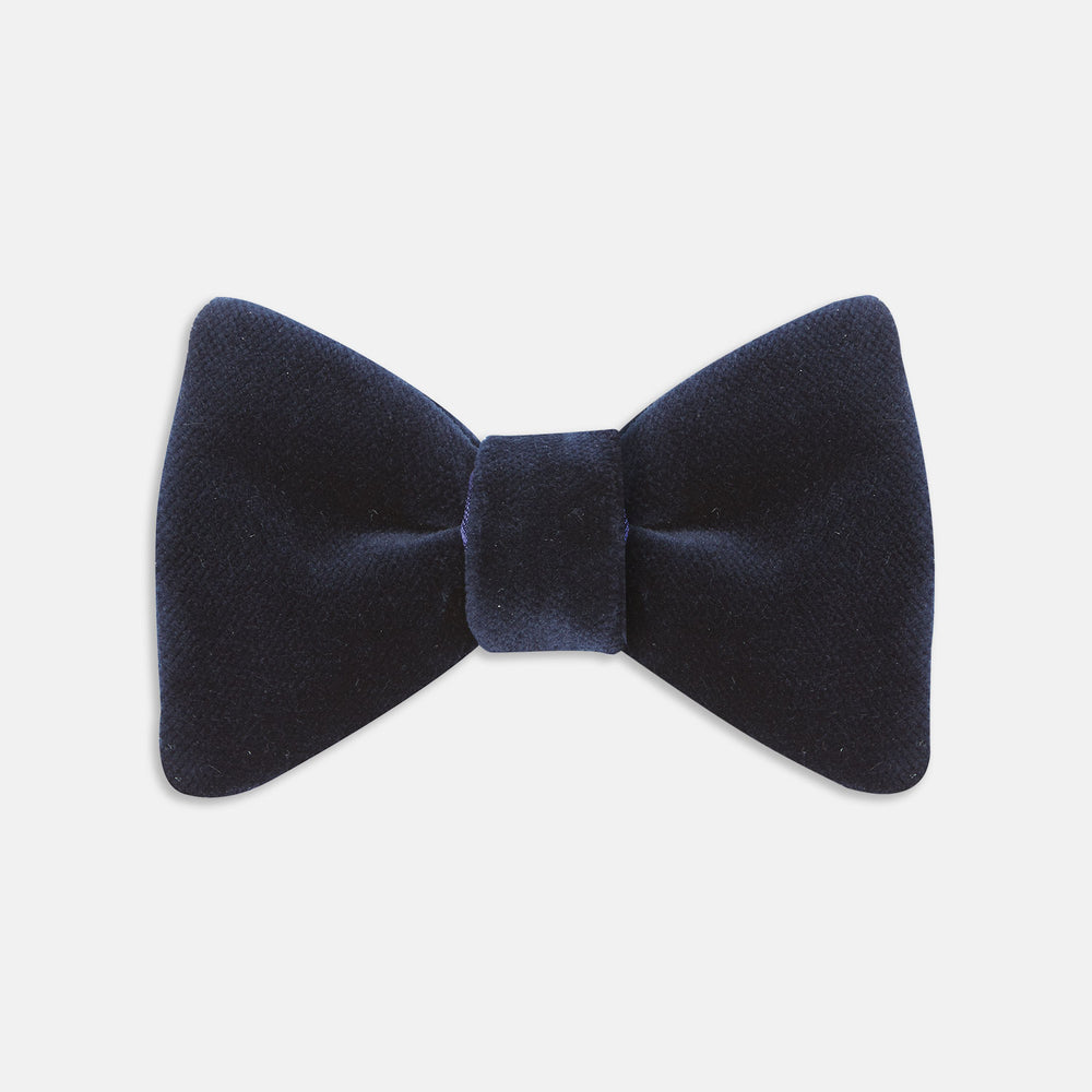 The Turnbull & Asser Navy Velvet Bow Tie, crafted from plush velvet, is shown against a white background—an elegant choice for formal occasions.