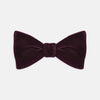 View 1 of product The Turnbull & Asser Purple Velvet Bow Tie is showcased on a plain white background, offering an elegant accessory to elevate any formal outfit with sophistication.