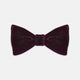 The Turnbull & Asser Purple Velvet Bow Tie is showcased on a plain white background, offering an elegant accessory to elevate any formal outfit with sophistication.