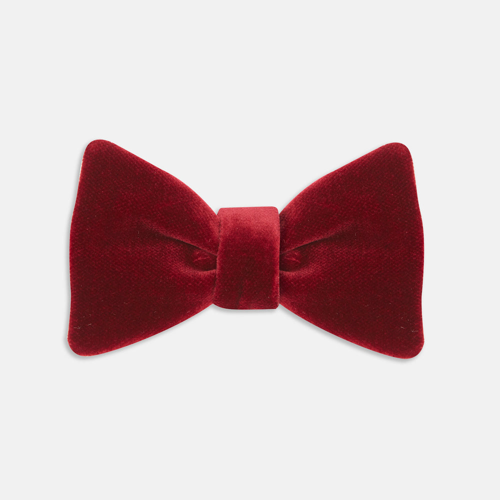 The Turnbull & Asser Burgundy Velvet Bow Tie features a soft, plush texture and is shown on a plain white background—an ideal accessory for formal soirées.