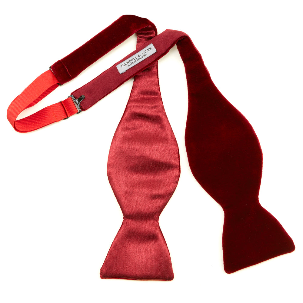 The Turnbull & Asser Burgundy Velvet Bow Tie features a soft, plush texture and is shown on a plain white background—an ideal accessory for formal soirées.