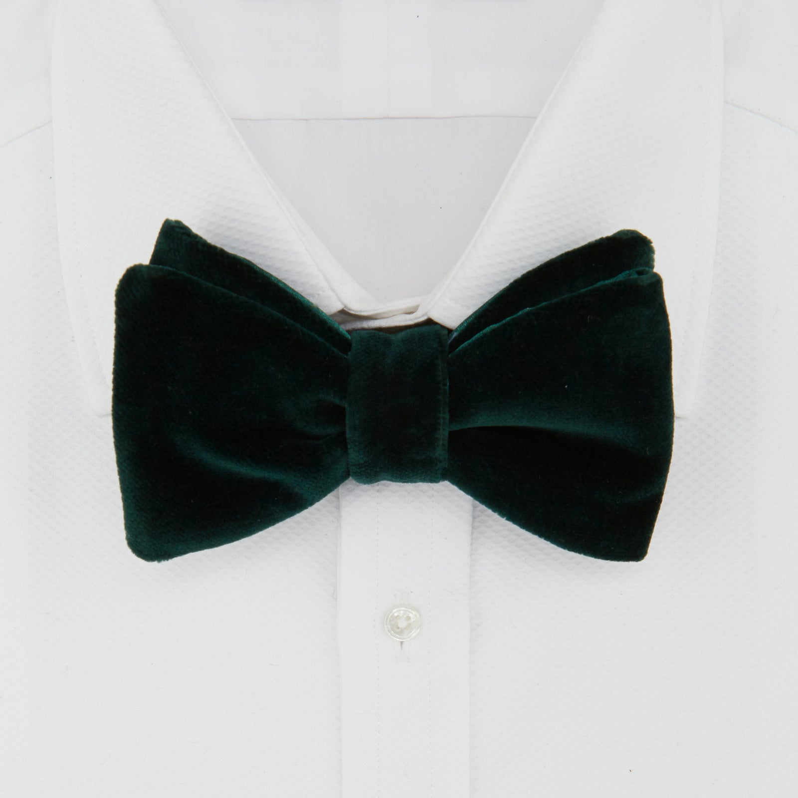 View 3 of product The Turnbull & Asser Green Velvet Bow Tie features a rich dark green hue and plush, smooth texture, ideal for formal events. Shown here against a plain white background.