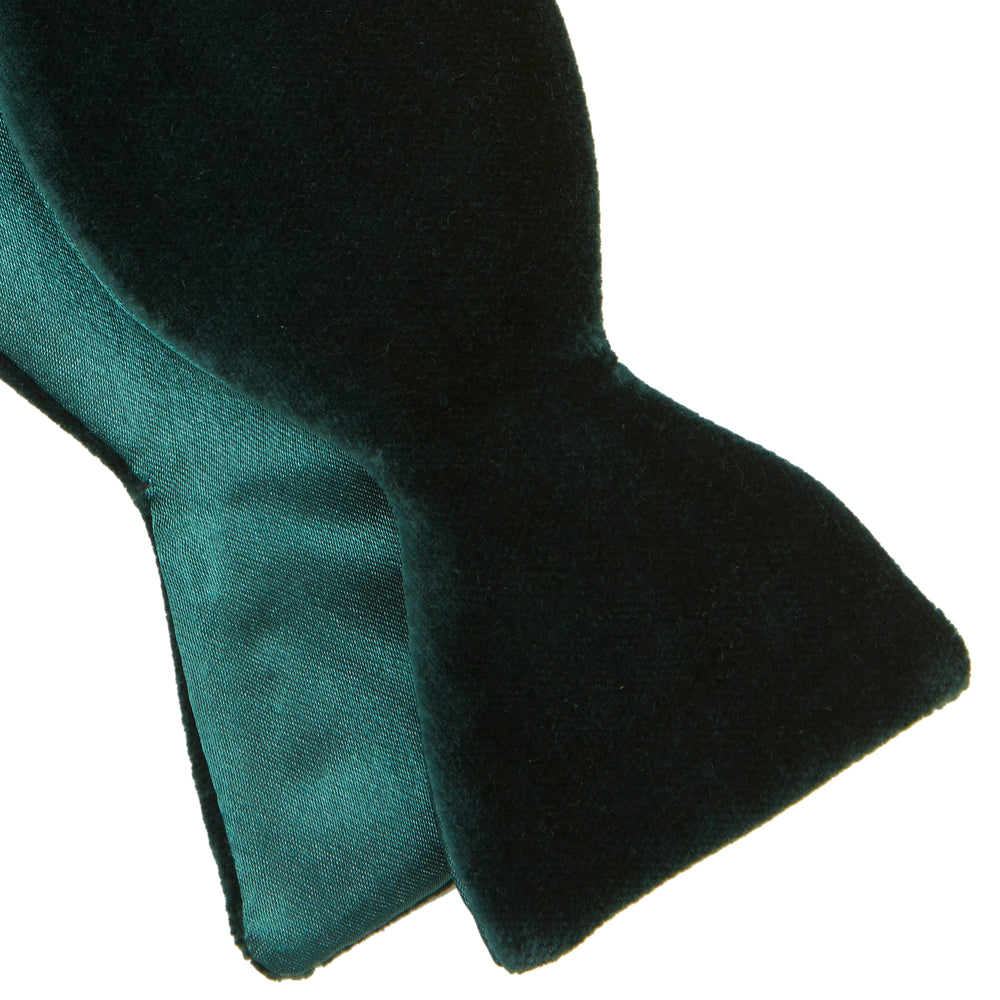 The Turnbull & Asser Green Velvet Bow Tie features a rich dark green hue and plush, smooth texture, ideal for formal events. Shown here against a plain white background.