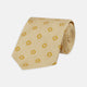 The Turnbull & Asser Soft Yellow Floral Jacquard Stripe Silk Tie features a rolled-up beige design with subtle texture and small yellow floral patterns evenly spaced throughout.