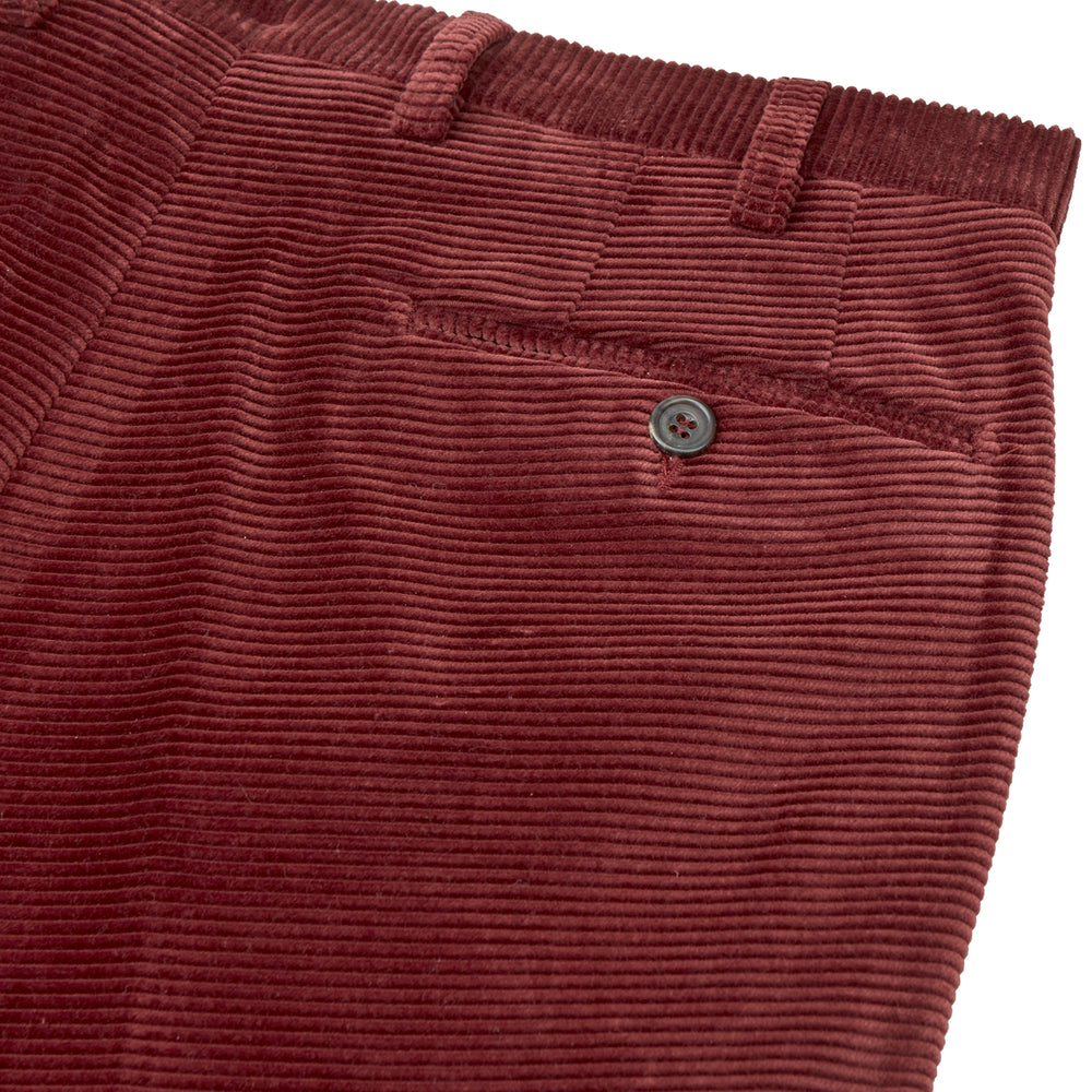 The Turnbull & Asser Copper Horizontal Corduroy Trousers are standout straight-leg burgundy pants with button and zip closure, shown against a plain white background.