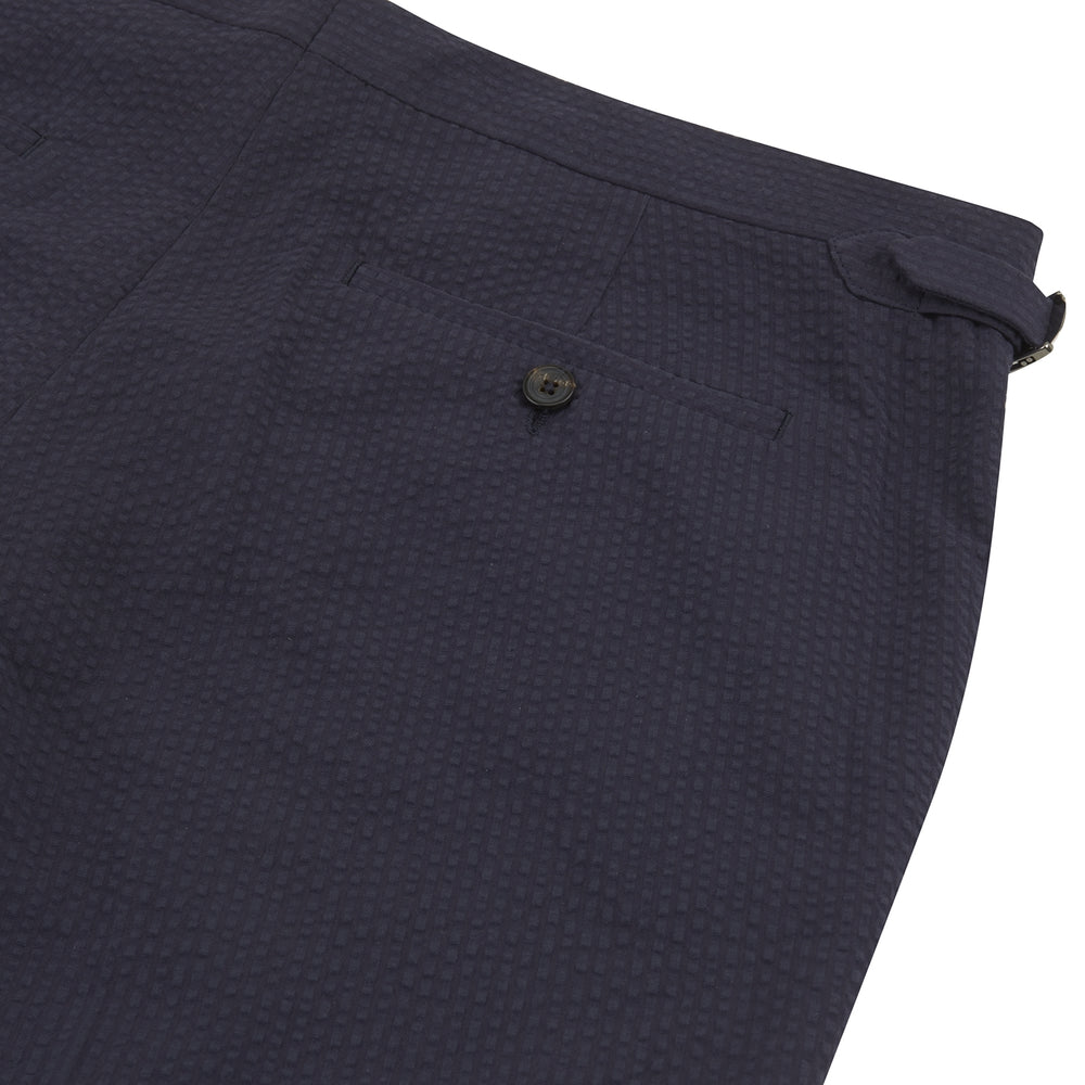 Turnbull & Asser Navy Cotton Seersucker Trousers, featuring a straight-leg fit, belt loops, and concealed front closure, crafted from lightweight Italian seersucker fabric, displayed on a plain white background.