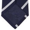 View 4 of product The Turnbull & Asser Seven-Fold Navy and White Blazer Stripe Repp Silk Tie, elegantly rolled at one end, is displayed on a plain white background.