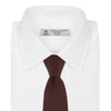View 2 of product The Turnbull & Asser Burgundy Ottoman Silk Tie features a heavyweight ribbed silk with a subtle diagonal wave pattern, shown rolled up on a plain white background.
