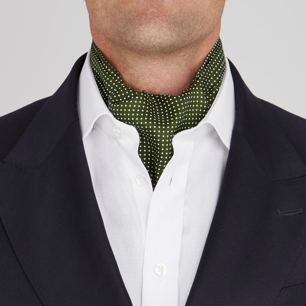 The Turnbull & Asser Olive Green and White Small Spot Silk Ascot Tie is a stylish accessory for wedding guests, featuring a classic pattern that pairs perfectly with a matching pocket square.