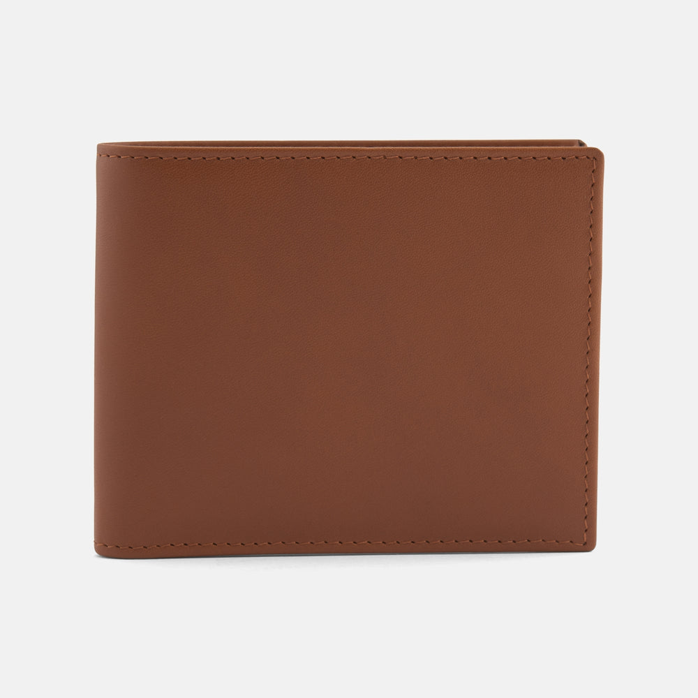 A closed Light Tan Leather Billfold by Turnbull & Asser stands upright against a plain white background, showcasing visible edge stitching and a smooth, minimalist design.